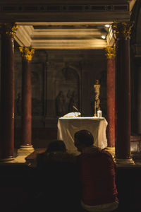 Rear view of people in temple against building