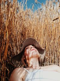 Portrait of woman lying on field