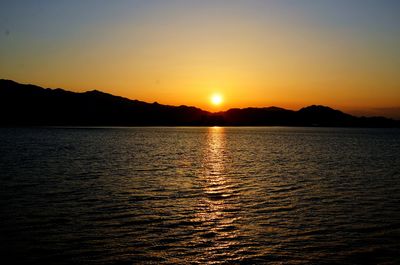 Scenic view of sea against clear sky during sunset