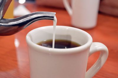 Close-up of served coffee cup on table