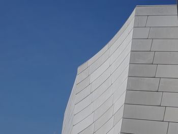 Low angle view of modern building against clear blue sky