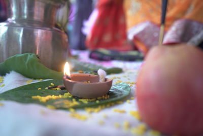 Close-up of lit candles on table