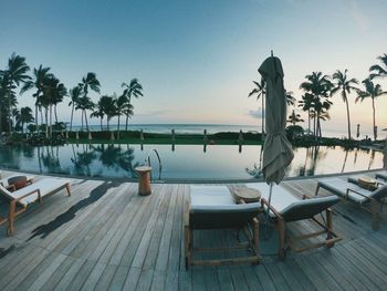 Scenic view of swimming pool by sea against sky