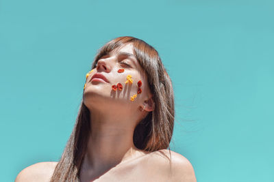 Portrait of woman against blue background