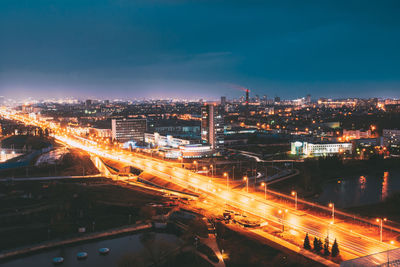 High angle view of illuminated city against sky at night