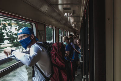 People standing on train window