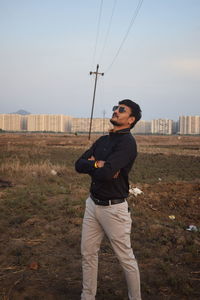 Full length of man standing on field against sky