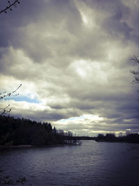 Scenic view of river against sky at dusk