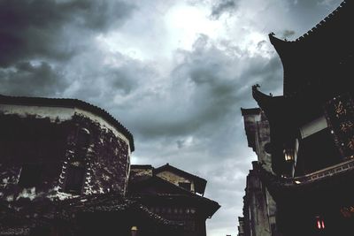 Low angle view of building against cloudy sky