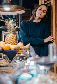 Young woman having food on table