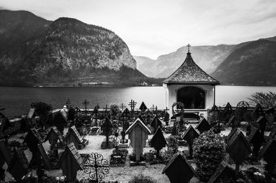 Panoramic shot of building by sea against mountains