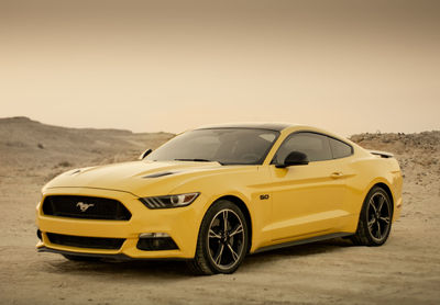 Yellow toy car on desert land