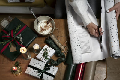 Womans hands wrapping christmas gift