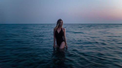 Sensuous woman walking on shore at beach