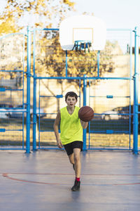 Man playing with ball in basketball court