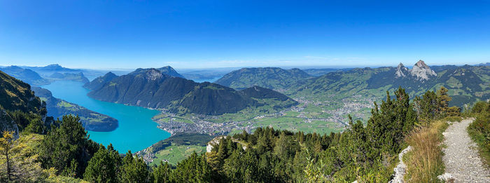 Panoramic view of mountains against clear blue sky