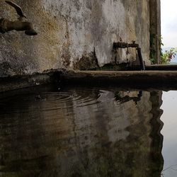 Old weathered wall by lake