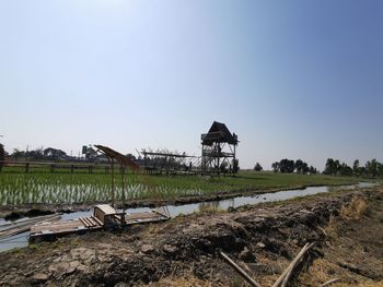 Scenic view of agricultural field against clear sky