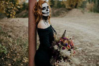 A couple in love is sitting hugging against the backdrop of mountains celebrating halloween in costu