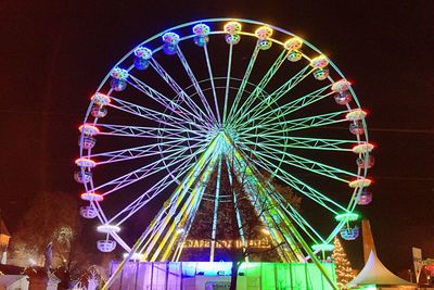 Low angle view of ferris wheel against sky at night