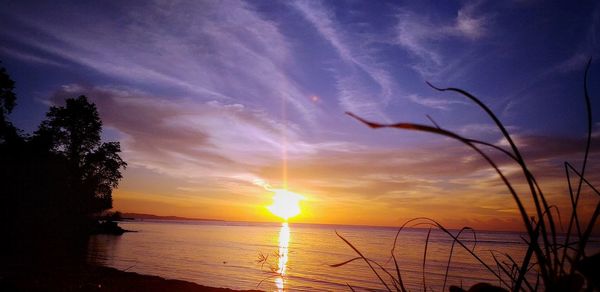 Scenic view of sea against orange sky