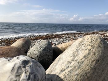 Rocks on sea shore against sky