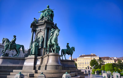 Low angle view of statue against blue sky