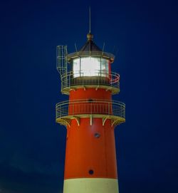 Low angle view of lighthouse against sky at night