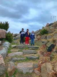 People standing on staircase against sky