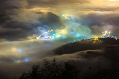 Scenic view of storm clouds over mountains