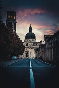 Road amidst buildings against sky in city