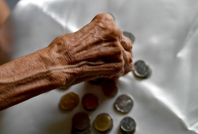 Cropped hand of person holding dentures