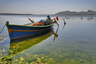 Boats moored on sea against sky