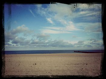 Scenic view of sea against cloudy sky