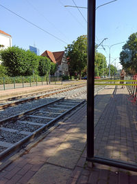 Railroad tracks by buildings against sky