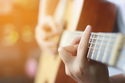 Close-up of hand playing guitar