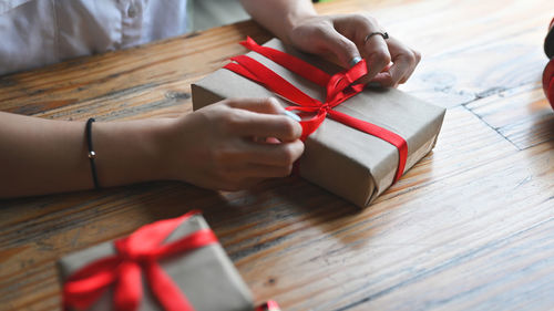 High angle view of woman hand on table