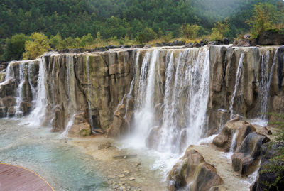 Scenic view of waterfall in forest