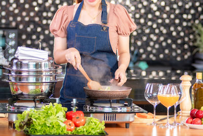 Midsection of woman preparing food on table