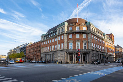 City street by buildings against sky