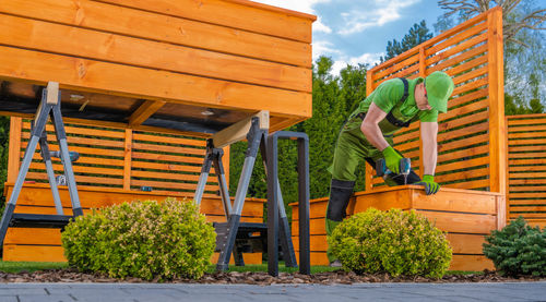 Side view of man standing by plants