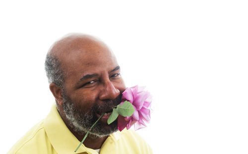 Close-up portrait of man against white background