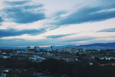 Cityscape against cloudy sky