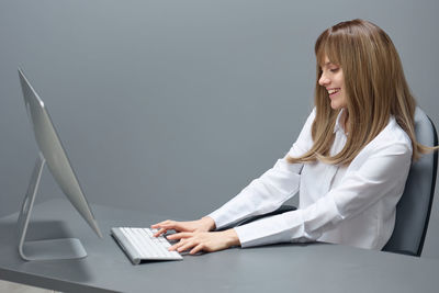 Young woman using laptop at office