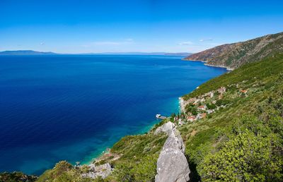 View of calm beach against blue sky