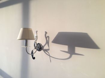 Close-up of electric lamp hanging on metal