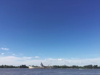 Scenic view of sea against blue sky