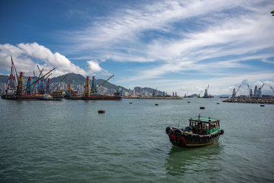 Commercial dock by sea against sky