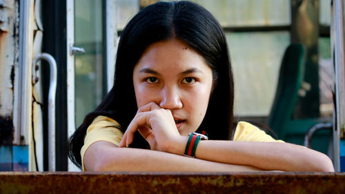 Portrait of young woman sitting outdoors