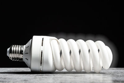 Close-up of light bulb against black background